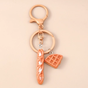 Detailed macro view of realistic baguette and waffle resin pendants on a metal keychain