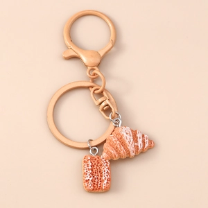 Detailed macro view of croissant and pastry keychain charms with realistic textures