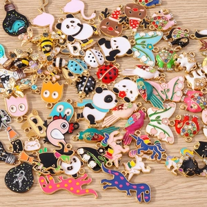 Detailed flat lay of colorful enamel animal charms with pandas and butterflies