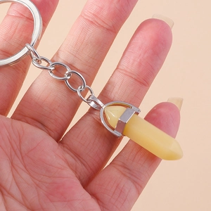Detail of a hexagonal crystal pendant keychain with polished metal ring and chain