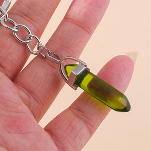 Detail of green hexagonal resin pendant with silver metallic keychain chain links