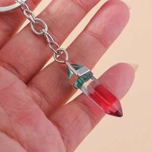Macro view of a resin hexagonal column keychain with red and green inner fluid