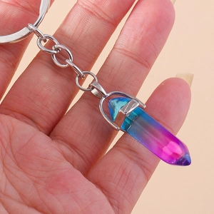 Close-up of a blue and purple gradient hexagonal crystal pendant on a silver keychain