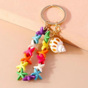 Detailed close-up of colorful starfish beads and seashell charms on a gold keychain