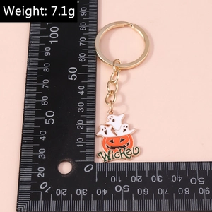 Halloween pumpkin and ghost keychain with Wicked text and gold plating detail