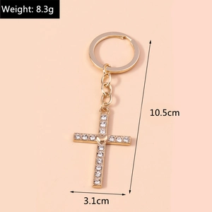 Detail view of gold rhinestone cross keychain showing dimensions 10.5cm by 3.1cm and 8.3g