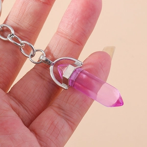 Macro view of purple hexagonal crystal pendant with silver metal clasp on key ring