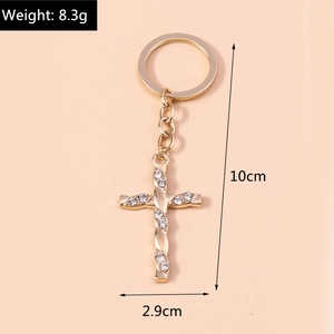 Detailed view of golden twisted cross keychain with rhinestones and size measurements