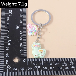 Detail view of cute alpaca keychain with cloud charm showing 7.1g weight on a scale