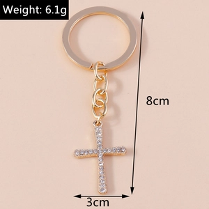 Detail view of crystal rhinestone cross keychain with 8cm length and 3cm width measurements