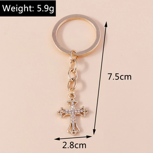 Detailed view of rhinestone cross keychain with dimensions 7.5cm by 2.8cm and 5.9g weight