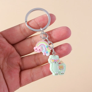 Detail of cute resin alpaca and rainbow cloud charms on a silver metal keychain