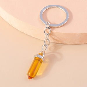 Detail showing amber hexagonal crystal pendant and polished silver metal keychain ring