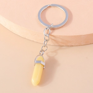 Macro shot of light yellow hexagonal crystal pillar keychain with silver metal edge