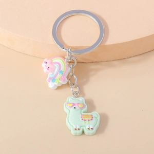 Detailed view of mint green alpaca keychain with rainbow cloud charm on gold hardware