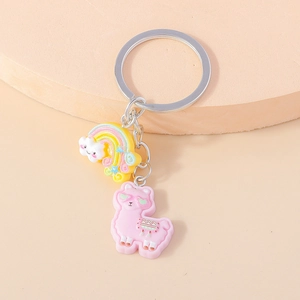 Detail of cute pink alpaca and rainbow cloud keychain with polished silver metal ring