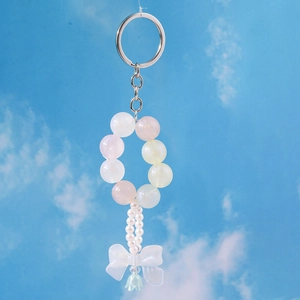 Detailed view of trendy beaded bow keychain with pearls and tulip pendant charm