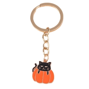 Halloween keychain with a cute black cat inside an orange pumpkin on a golden ring