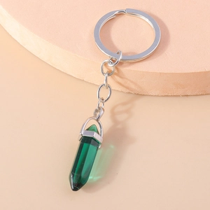 Detailed macro view of dark green hexagonal crystal pendant on polished silver keychain