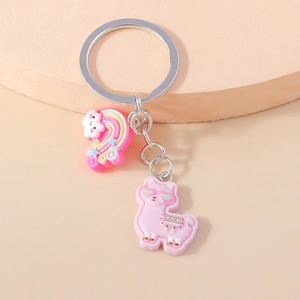Detailed shot of pink cartoon alpaca keychain with rainbow pendant on a round stand
