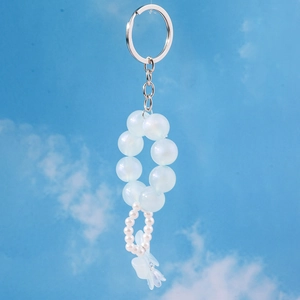Close-up of light blue iridescent beads and white pearl keychain with flower charm