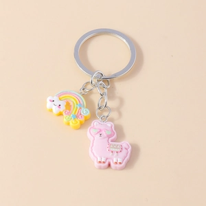 Close-up of pink llama keychain with heart glasses and colorful rainbow cloud charm