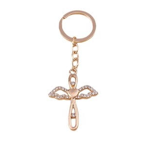 Golden cross and wings keychain pendant with white rhinestones and heart design