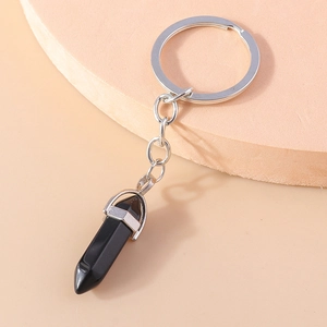 Detailed view of hexagonal black obsidian pendant with silver metal keychain ring