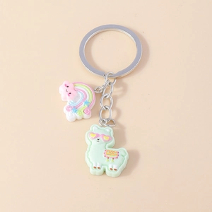 Detail of cute rainbow alpaca and cloud keychain charms on a silver metal ring