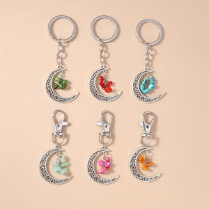 Detail view of hollow crescent moon keychains with colorful stone beads in a 3x2 grid layout