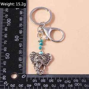 Detailed view of bohemian elephant keychain with turquoise beads and 15.2g weight measurement