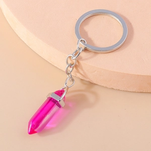 Detail of rose pink crystal hexagonal bullet pendant with silver metal keychain ring
