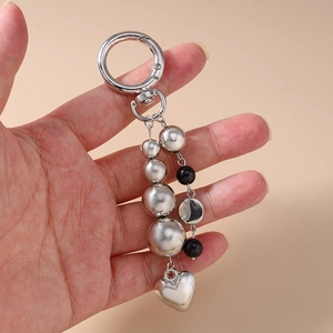 Handheld beaded keychain with silver and black beads featuring a metal heart pendant