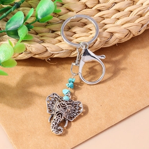 Ethnic elephant keychain with turquoise accents and retro floral silver metal details