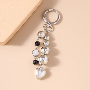 Elegant bead keychain with heart pendant and bow, premium metallic bag accessory