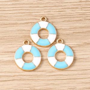 Detail of light blue and white lifebuoy charms with gold trim for DIY jewelry making
