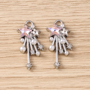 Detail view of Y2K star pendants with pink faceted gemstones and white pearls charms