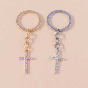 Detail of sparkling rhinestone encrusted cross keychains in gold and silver plating