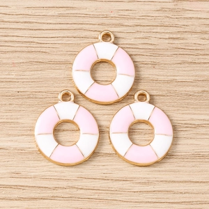Detail of lifebuoy-shaped charms with pink and white enamel for DIY jewelry making