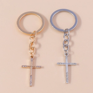 Detailed macro view of crystal rhinestone cross keychains in gold and silver finishes