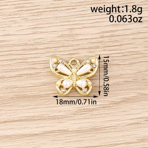 Detailed view of butterfly pendant charms showing white pearl and rhinestone inlay details