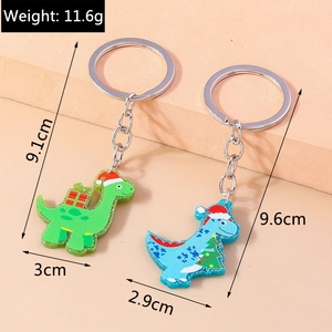 Detailed view of Christmas dinosaur keychains with acrylic glitter and silver metal ring