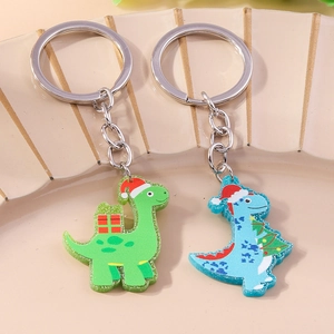 Glittery acrylic Christmas dinosaur keychains with festive hats and holiday gifts