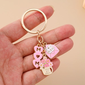 Golden Mom heart keychain featuring pink envelope and flower watering can pendants