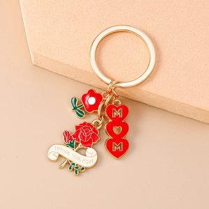 Detailed view of Mom heart keychain with red rose and Thank You Mom ribbon charms