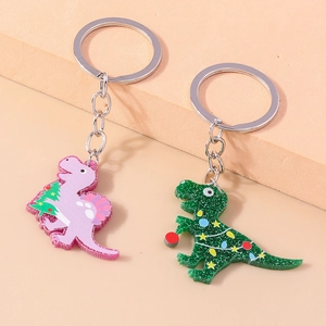Detail of Christmas themed acrylic dinosaur keychains with glitter finish and metal rings