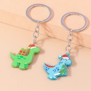 Detail of Christmas dinosaur keychains featuring green and blue acrylic dinosaurs