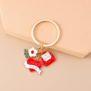 Detail of gold keychain with heart, envelope, and flower charms for Mother's Day gift