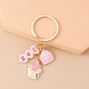 Detailed shot of Mother's Day gold keychain with heart, envelope and flower charms