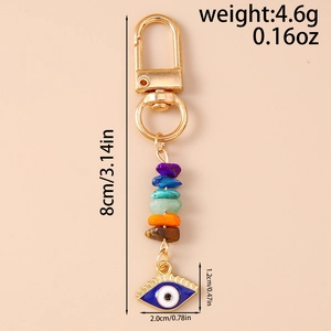 Detail view of evil eye keychain with natural colorful stones and 8cm length measurement